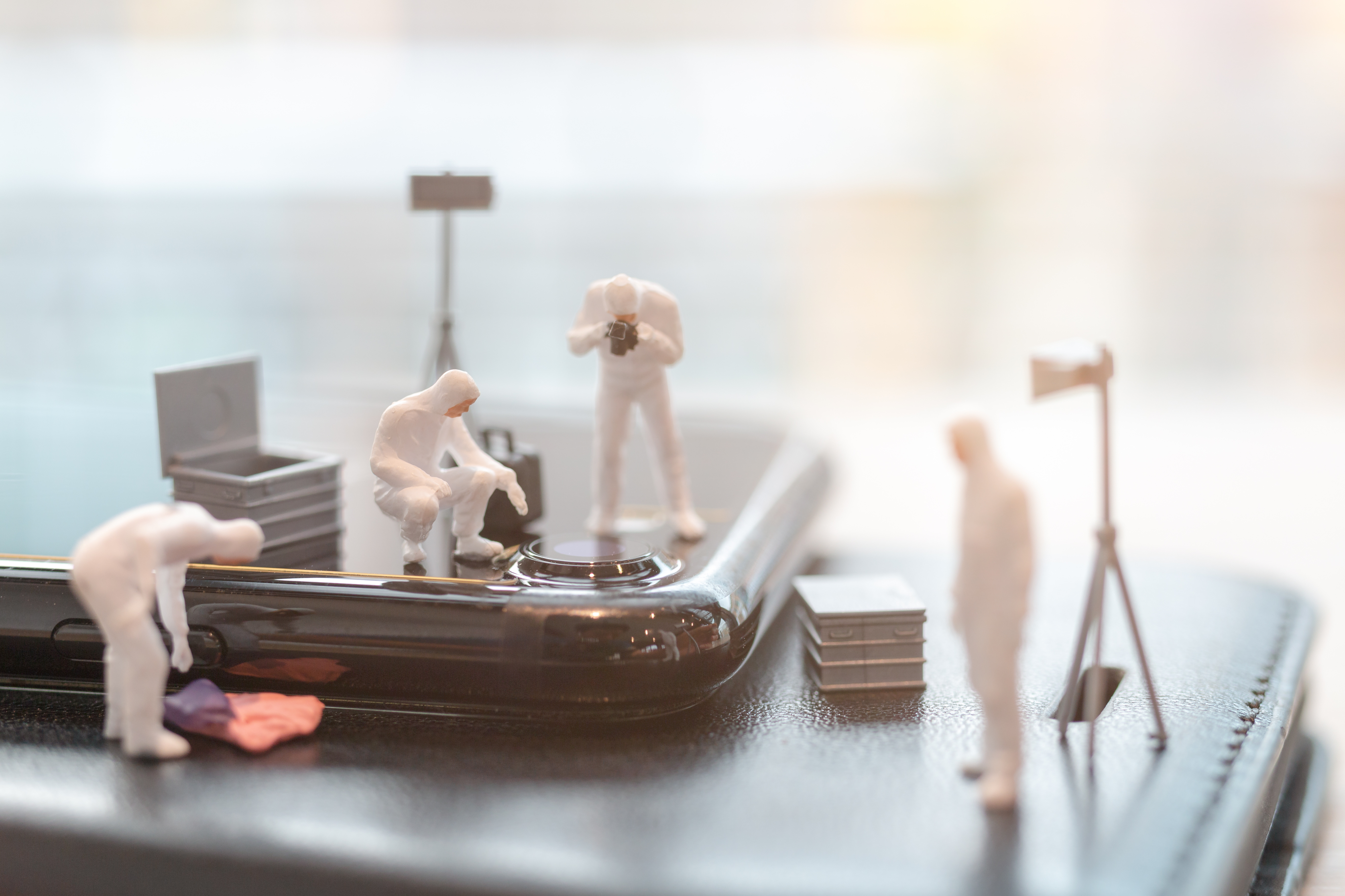 Miniature people : Police And Detective are working on smartphone , Crime scene investigation , Cyber crimes concept