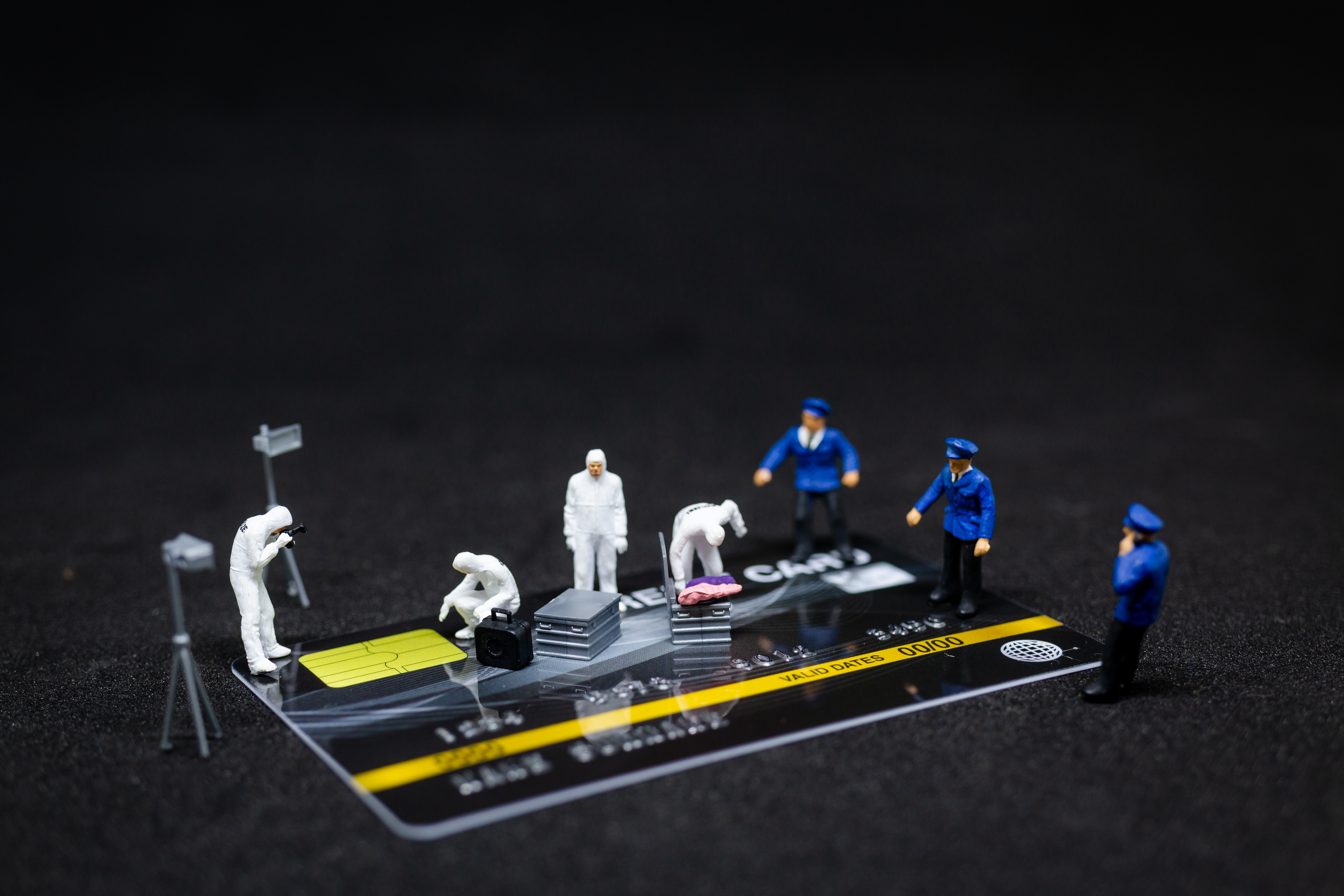 Miniature people : Police And Detective finding proof from credit card in crime scene, Cyber crime concept